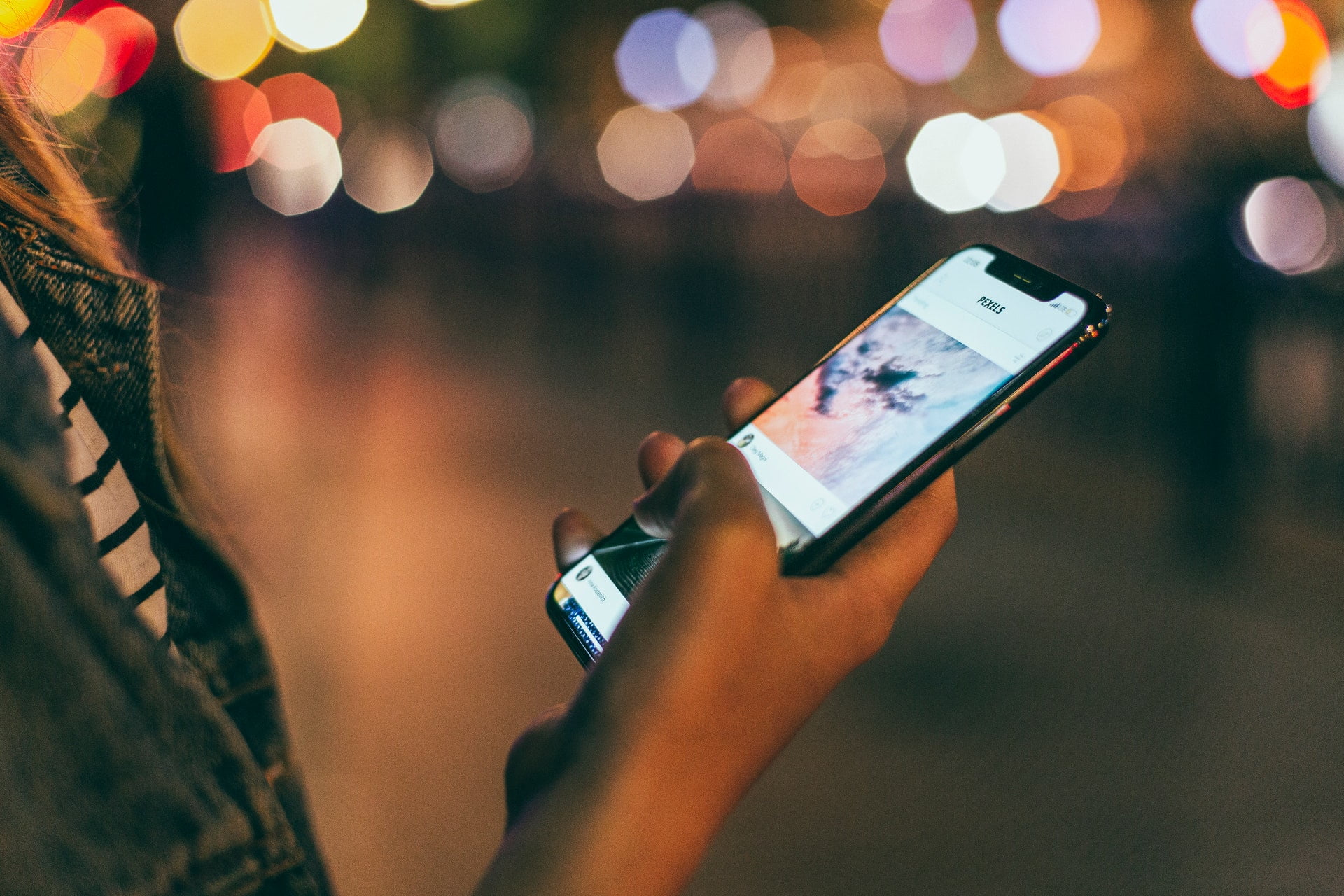 An image of a hand scrolling through a phone