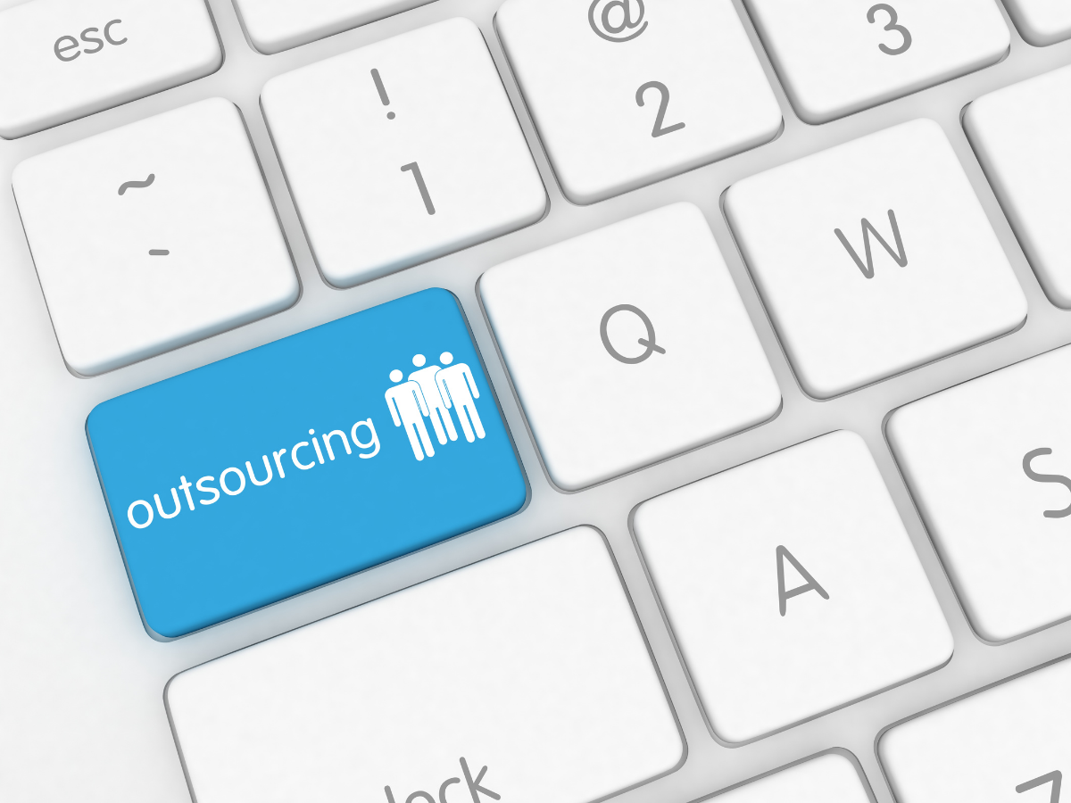 An image of a blue "Outsourcing" button on a keyboard